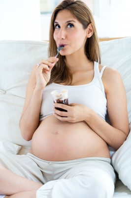 Pregnant Woman Eating Yogurt by nenetus / www.freedigitalphotos.net